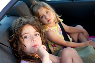 little girls inside car eating candy stick selective focus